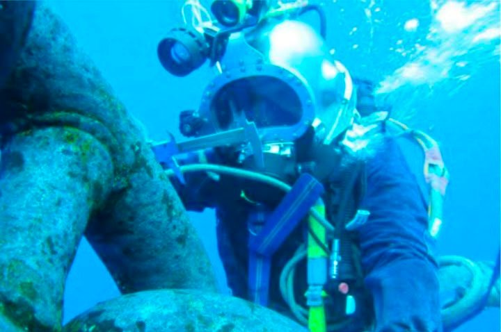 Diver polishing a vessel propeller